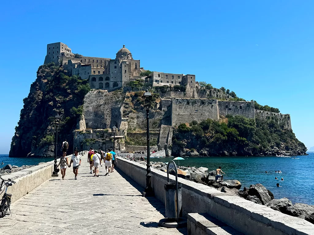 ischia ponte bridge with aragonese castle behind