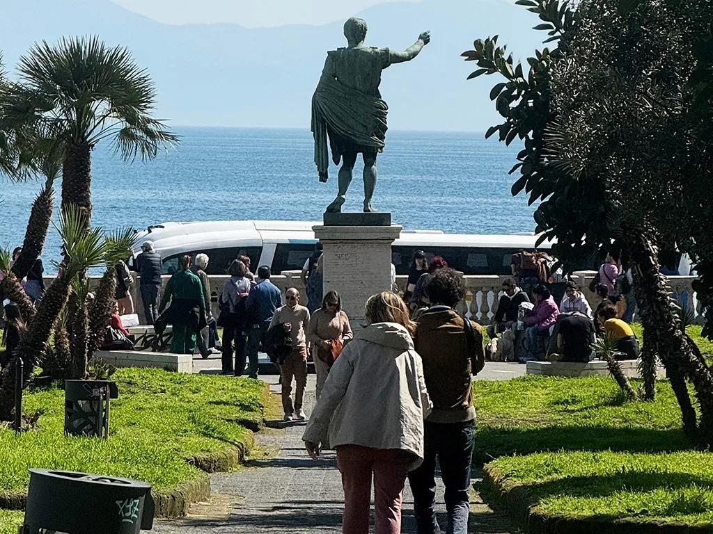 statue of augustus surrounded by people