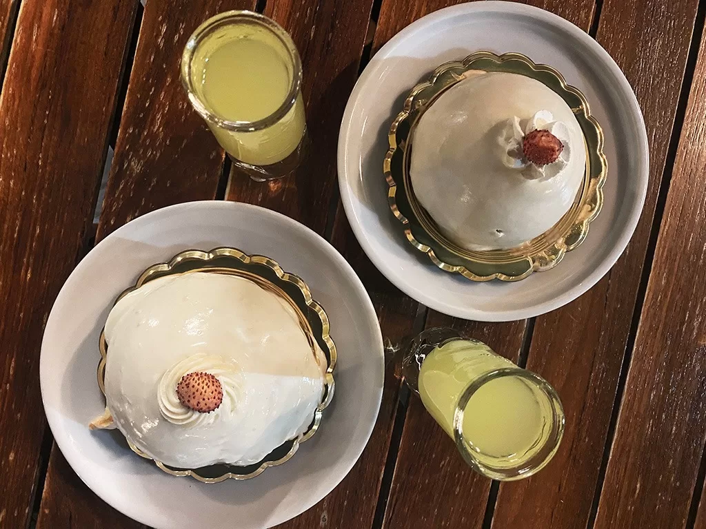 two delizia di limone desserts and two shots of limoncello