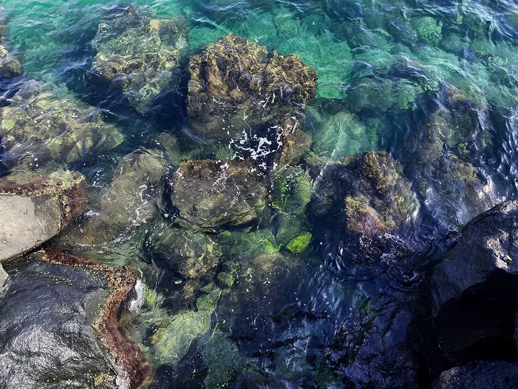 close up of waves crashing over rocks