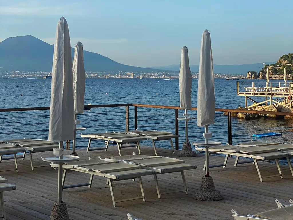 sunbeds and umbrellas at sunset in vico equense