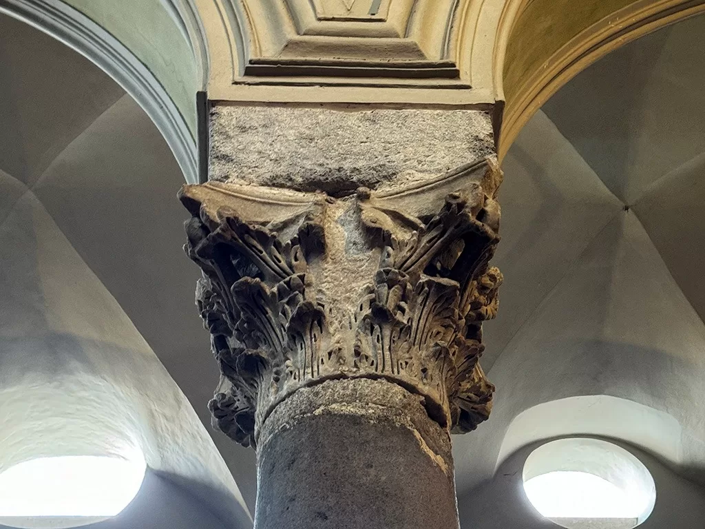 close up of ancient roman capitol on top of column in naples cathedral