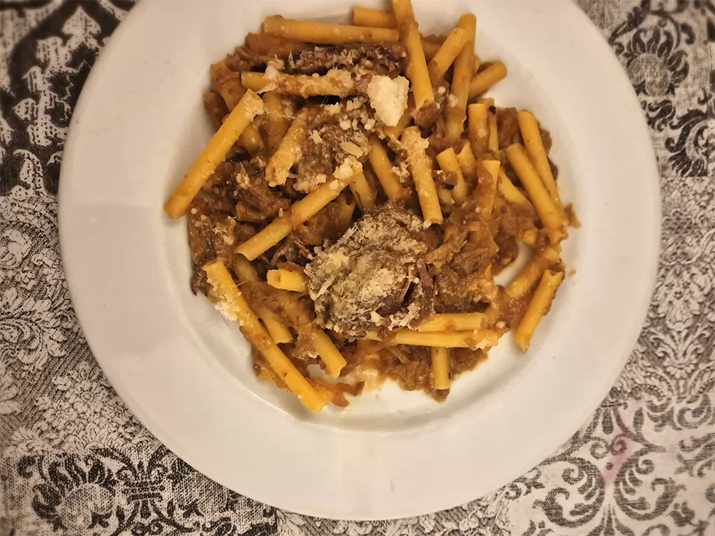 pasta ziti genovese on white plate