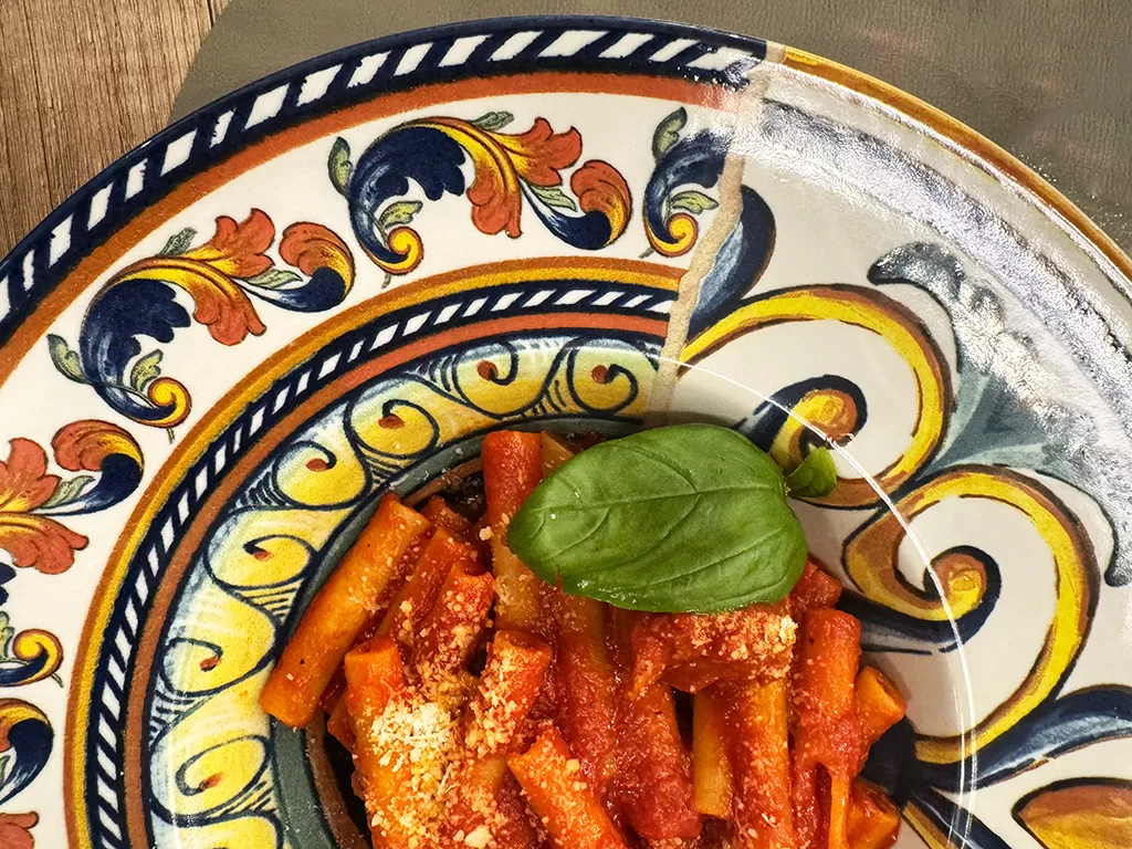 neapolitan ragu on colorful ceramic plate
