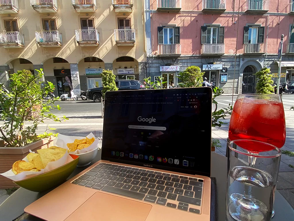laptop on table with spritz and chips