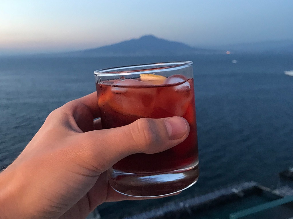negroni close up with view of bay of Naples behind
