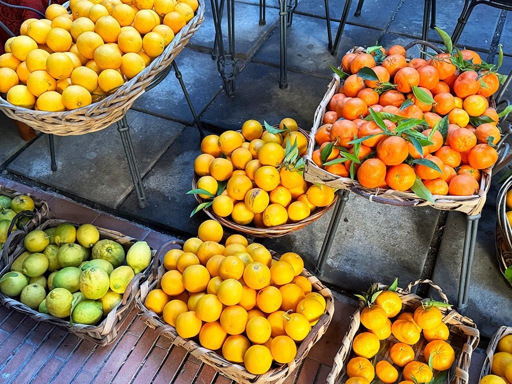 oranges and lemons on display in baskets in sorrento