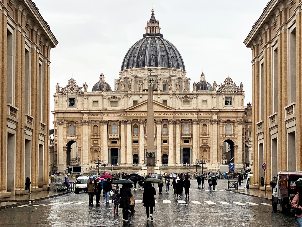 rainy day on road leading up to st peter's square and basilica