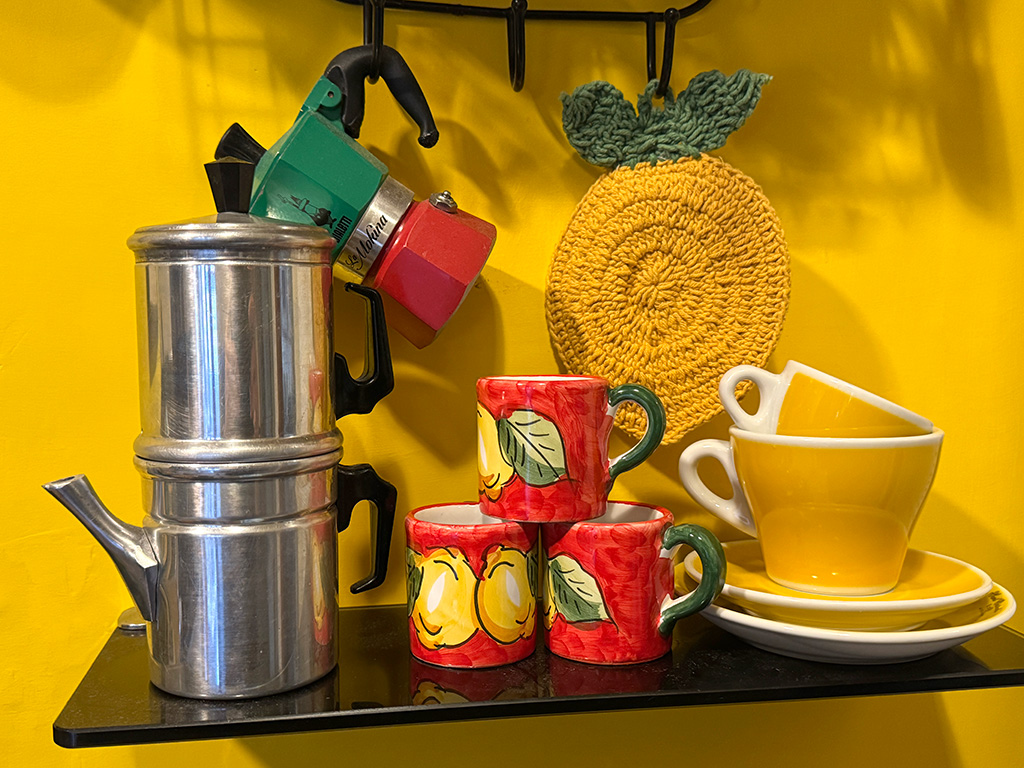 shelf with neapolitan moka pot, bialetti moka pot and ceramic espresso cups